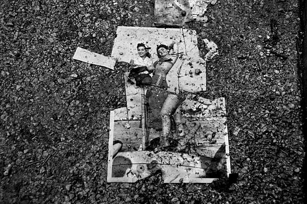 Torn photo on asphalt © Fouad Elkoury